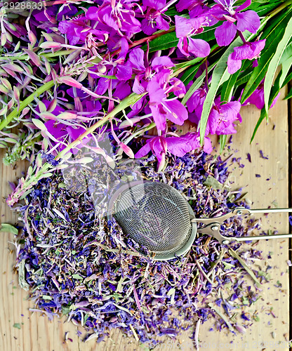 Image of Herbal tea with strainer of fireweed on board