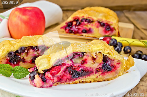 Image of Strudel with black currants and apples on board