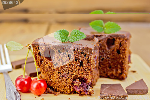 Image of Cake chocolate with cherries on board