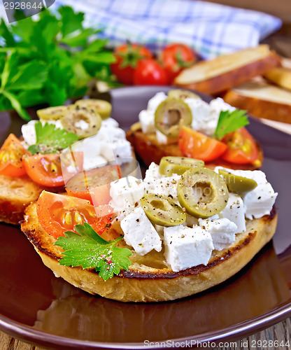 Image of Sandwich with feta and olives on board