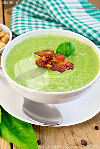 Image of Soup puree with bacon and spoon on board