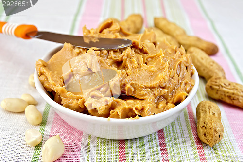 Image of Butter peanut with a knife on tablecloth