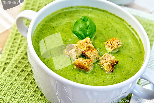 Image of Soup puree with croutons and spinach on napkin