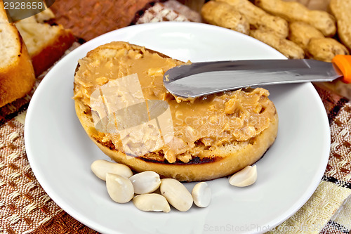 Image of Sandwich with peanut butter and knife on napkin