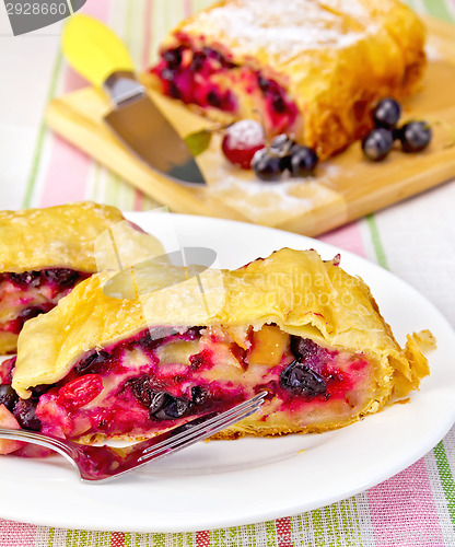 Image of Strudel with black currants on the tablecloth