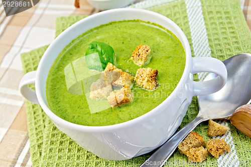 Image of Soup puree with croutons and spinach leaves on napkin