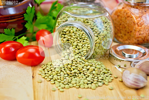 Image of Lentils green in jar with garlic on board