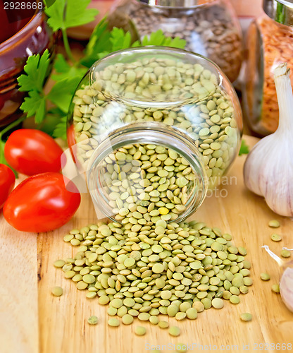 Image of Lentils green in jar with tomato on board