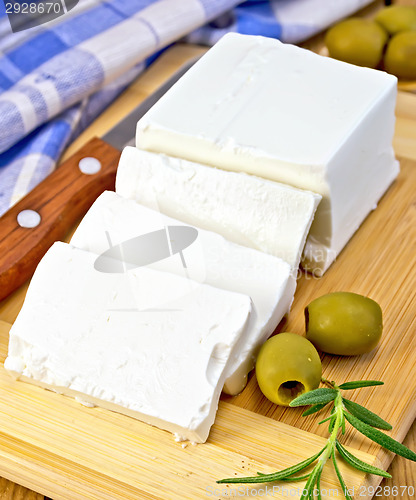 Image of Feta with olives on board with blue cloth