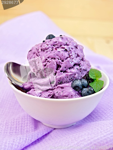 Image of Ice cream blueberry with spoon on napkin