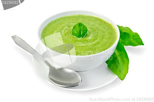Image of Soup puree with spinach in a bowl and leaves