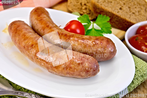 Image of Sausages pork fried in plate on board