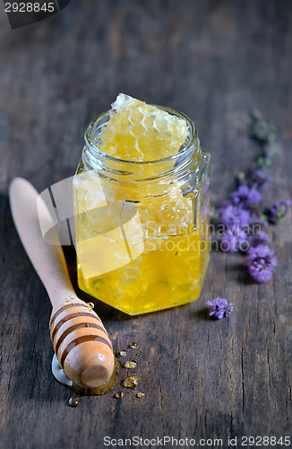 Image of honeycomb and honey in glass jars 