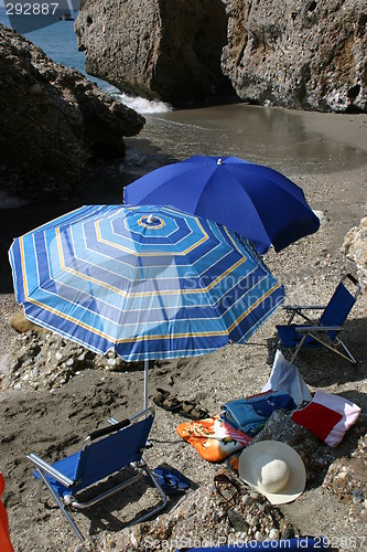 Image of Blue parasols on hidden beach