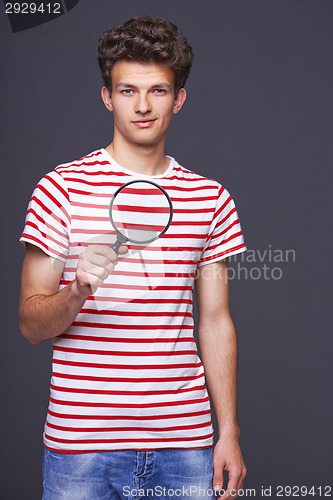 Image of Man holding magnifying glass