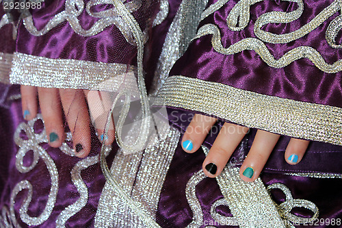 Image of girl's hands in Moroccan suit