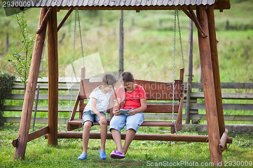 Image of Children with tablet outdoors