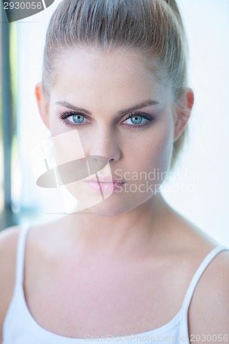 Image of Blue eyed young woman staring intently