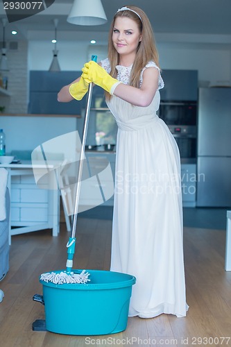 Image of Woman Wearing Wedding Gown with Mop and Bucket
