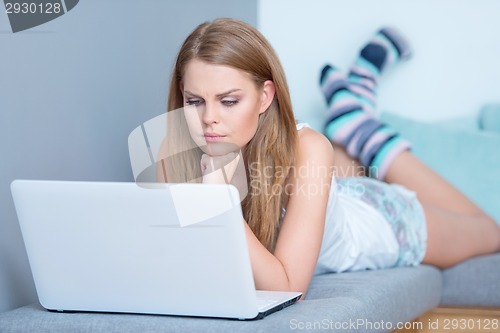 Image of Beautiful young woman using a laptop computer