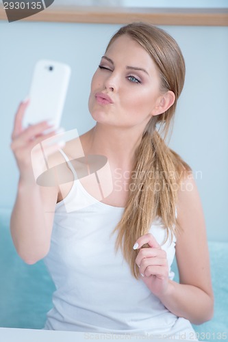 Image of Seductive young woman posing for a selfie