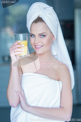 Image of Lady in towel holding glass of juice