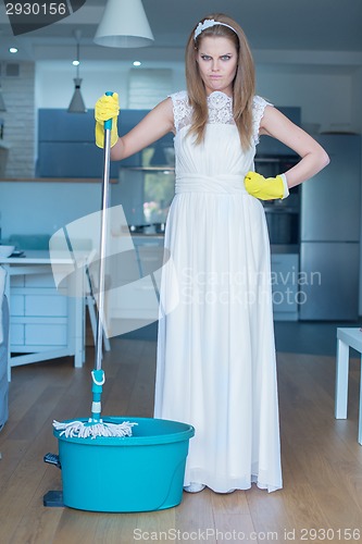 Image of Stern Woman Wearing Gown and Holding Mop