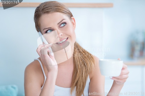 Image of Young woman listening to a phone conversation