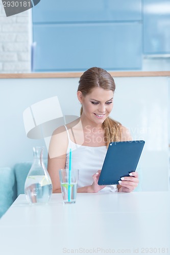 Image of Young woman surfing the internet on a tablet