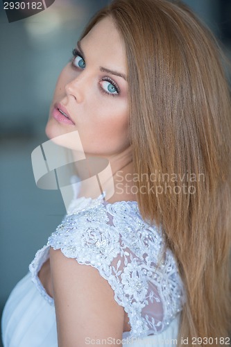 Image of Beautiful serious young woman with blue eyes