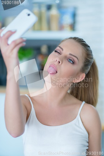 Image of Young woman taking a selfie on her mobile