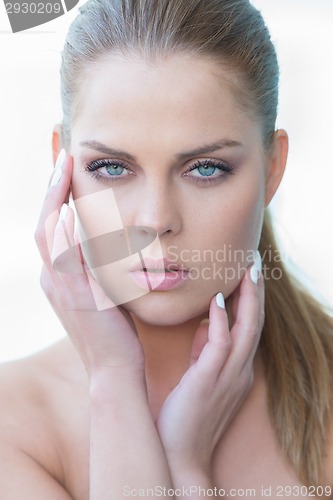 Image of Young Woman Touching Face with Hands
