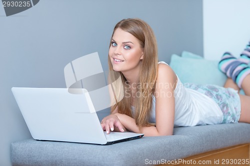 Image of Attractive young blond student working from home