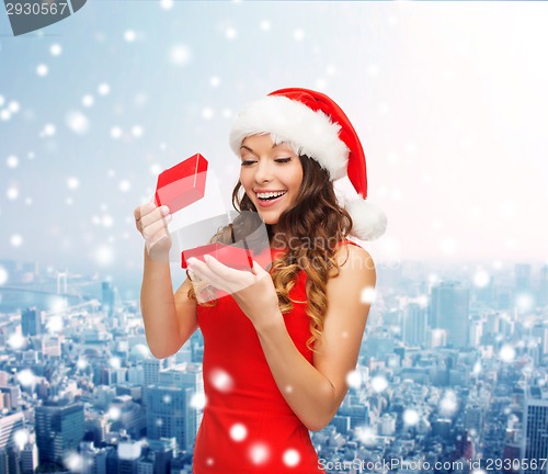 Image of smiling woman in santa helper hat with gift box
