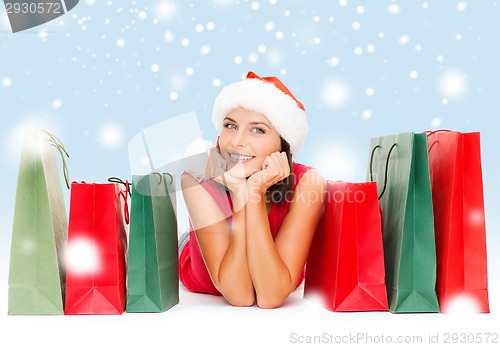 Image of woman in red shirt with shopping bags