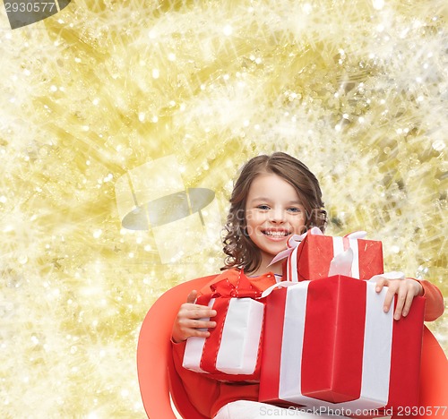 Image of smiling little girl with gift boxes