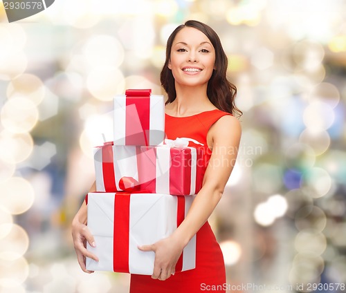 Image of smiling woman in red dress with gift box