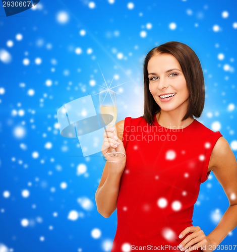 Image of smiling woman holding glass of sparkling wine