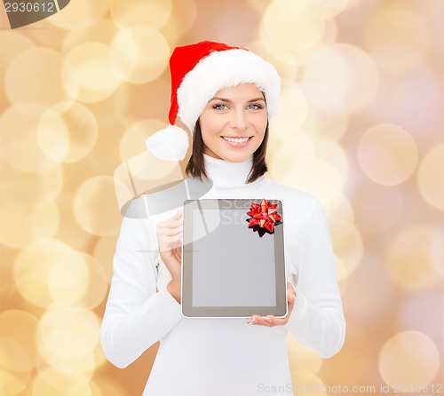 Image of woman in santa helper hat with tablet pc