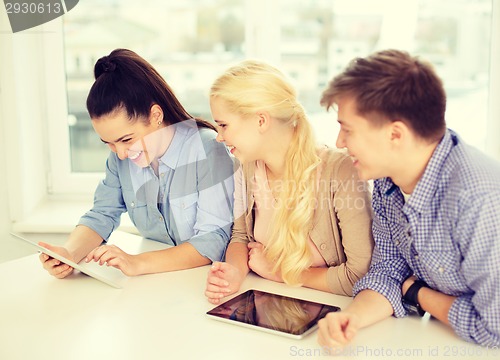 Image of smiling students with tablet pc computer at school