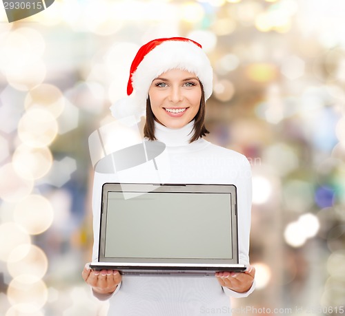 Image of woman in santa helper hat with laptop computer