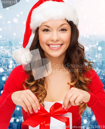 Image of smiling woman in santa helper hat with gift box