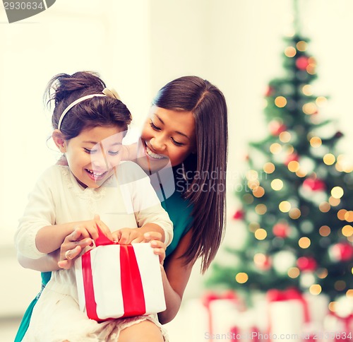 Image of happy mother and child girl with gift box