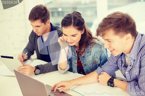 Image of students with laptop, notebooks and tablet pc