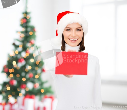 Image of woman in santa helper hat with blank red card