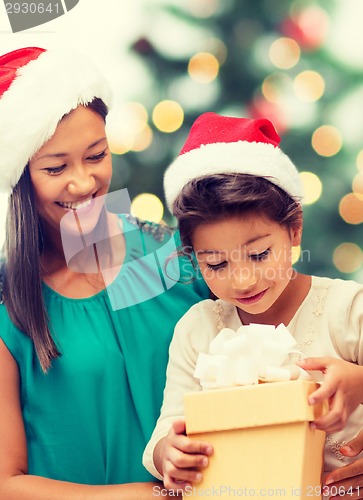 Image of happy mother and child girl with gift box