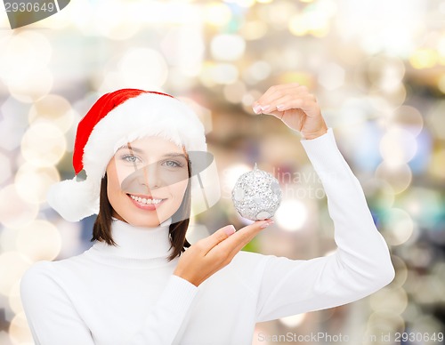 Image of woman in santa helper hat with christmas ball