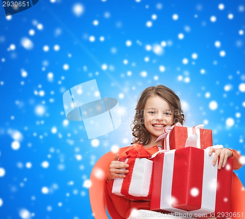 Image of smiling little girl with gift boxes