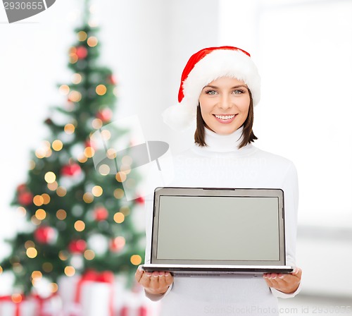 Image of woman in santa helper hat with laptop computer