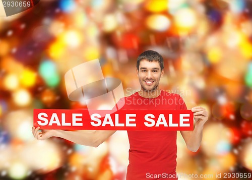 Image of man in red t-shirt with sale sign